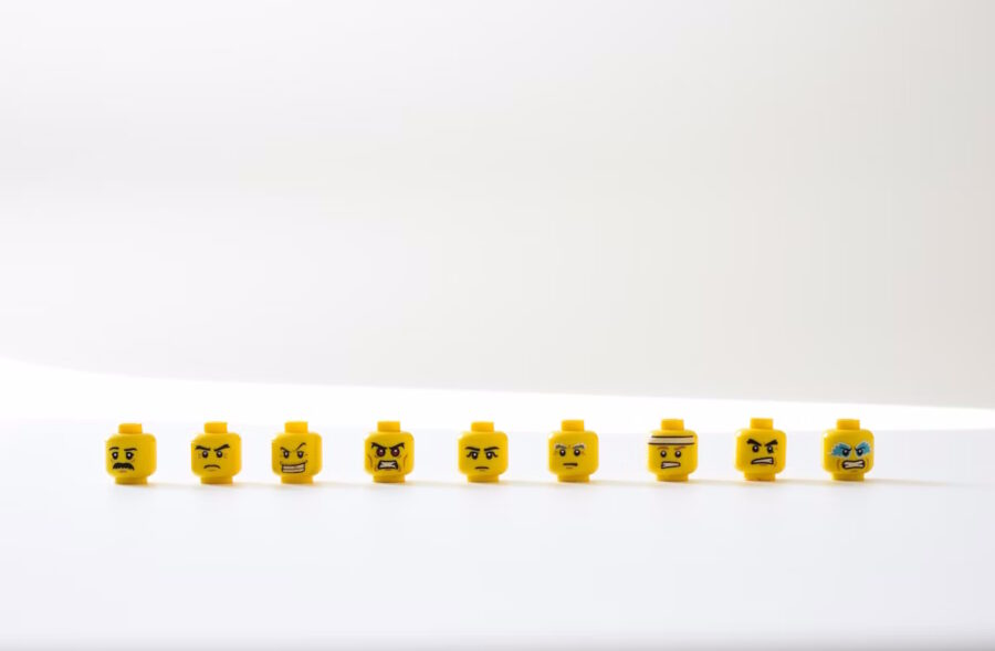 Row of yellow lego heads with various expressions of anger