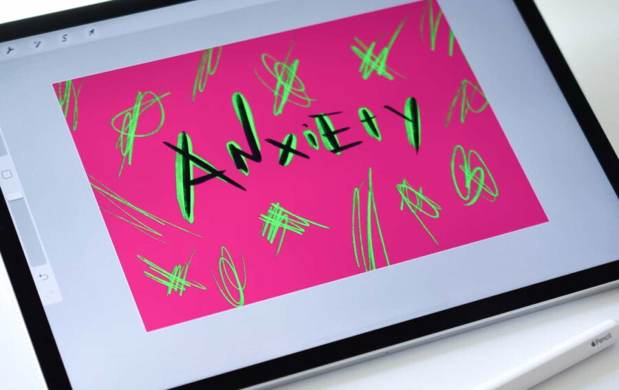 The word anxiety with a pink background and yellow doodles around it drawn on an iPad