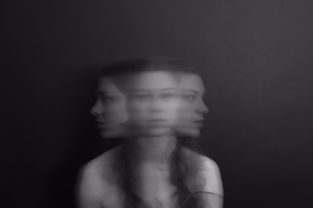 Photograph of woman with blurred effect making it appear as if she has three heads