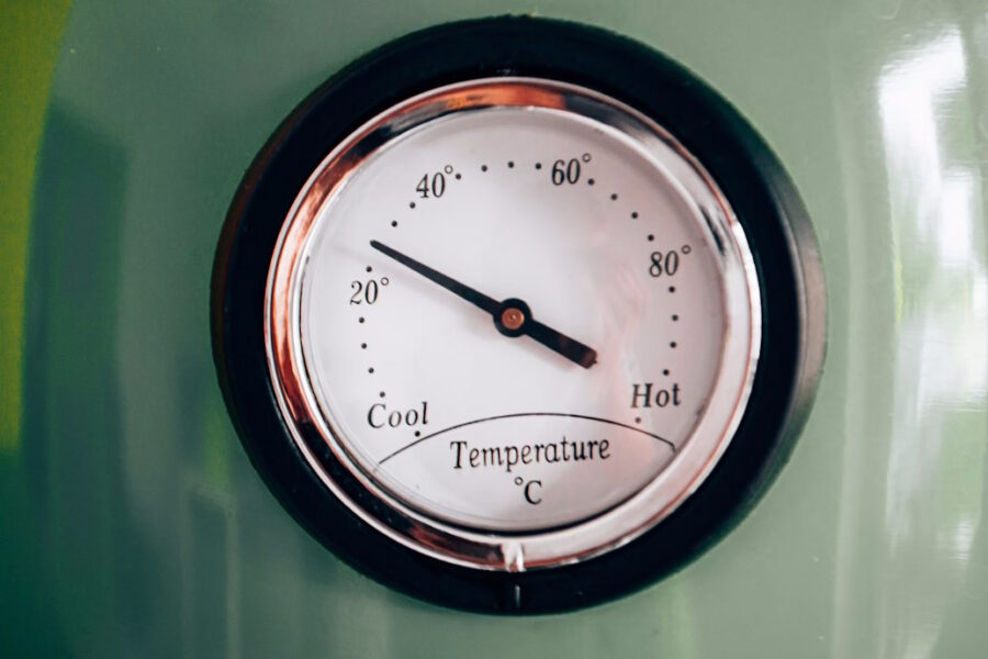 Old-fashioned temperature gauge reading cool to hot