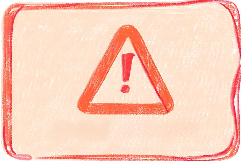 A red pencil drawing of a danger sign - a red triangle with an exclamation point in the centre