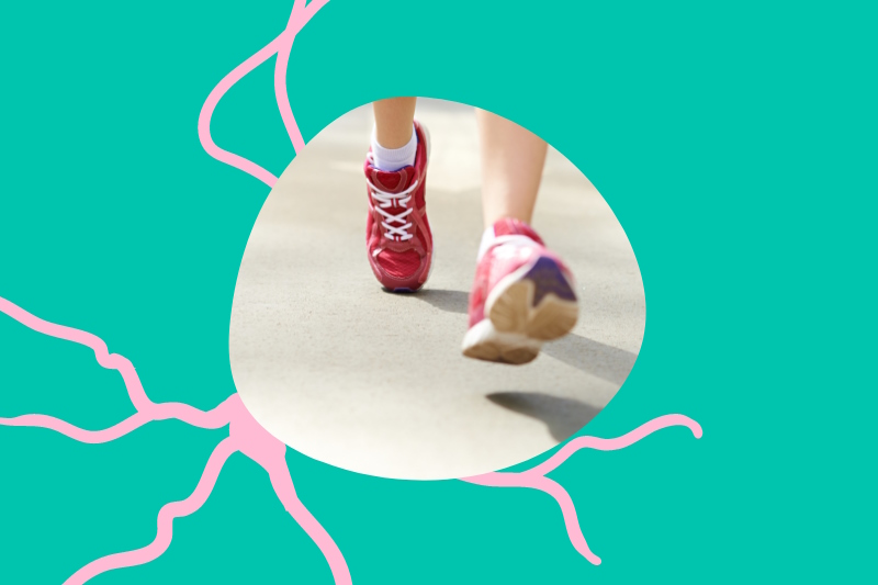 Photo of feet in trainers walking in the centre of a green and pink design