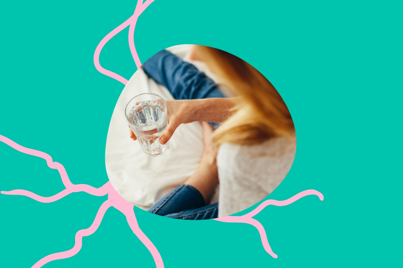 Photo of a person holding a glass of water in the middle of a pink and green design