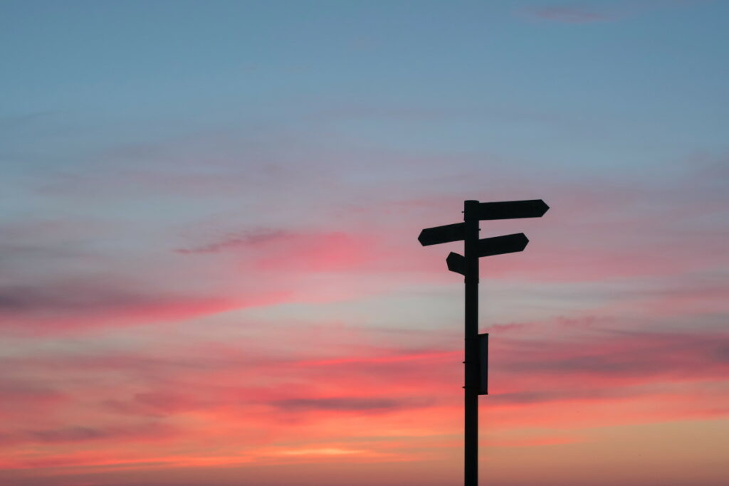 Silhouette of road sign during sunrise