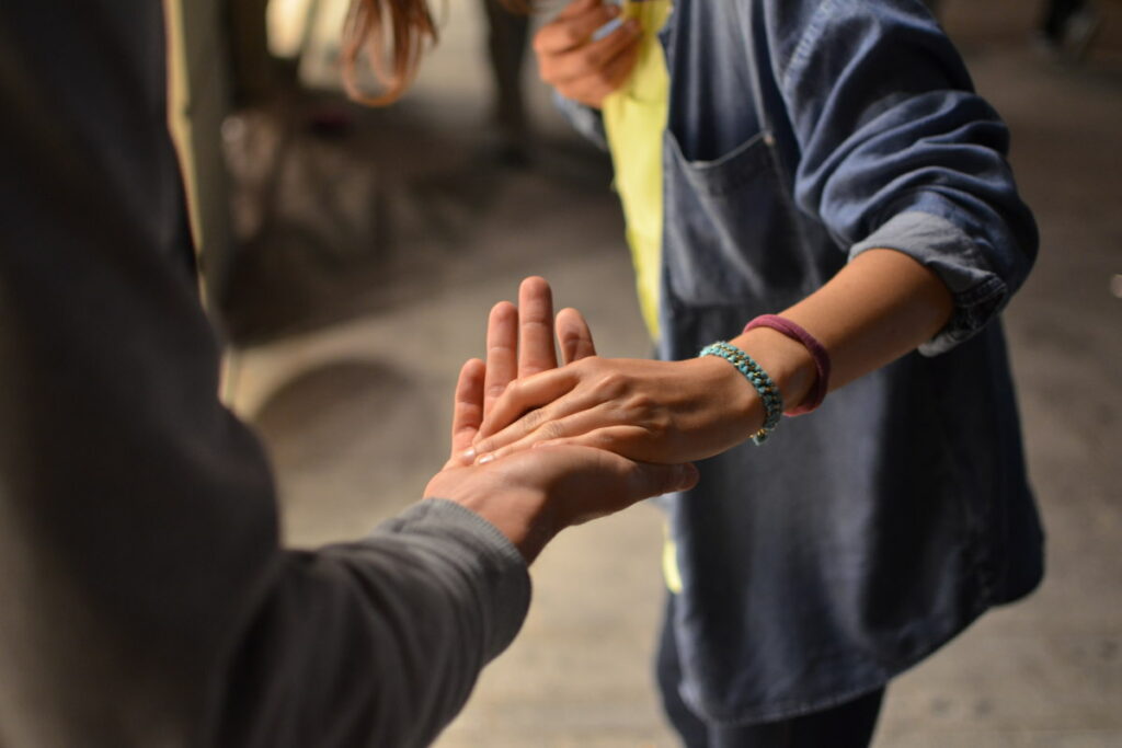 Two people holding hands with blurry background