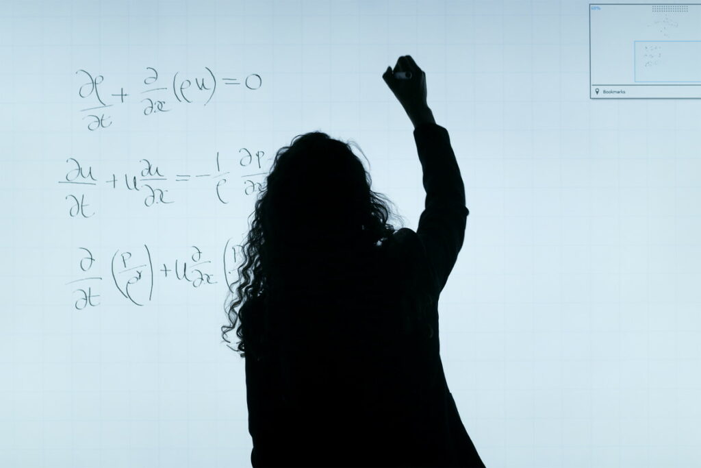 Woman out an equation on an electronic whiteboard